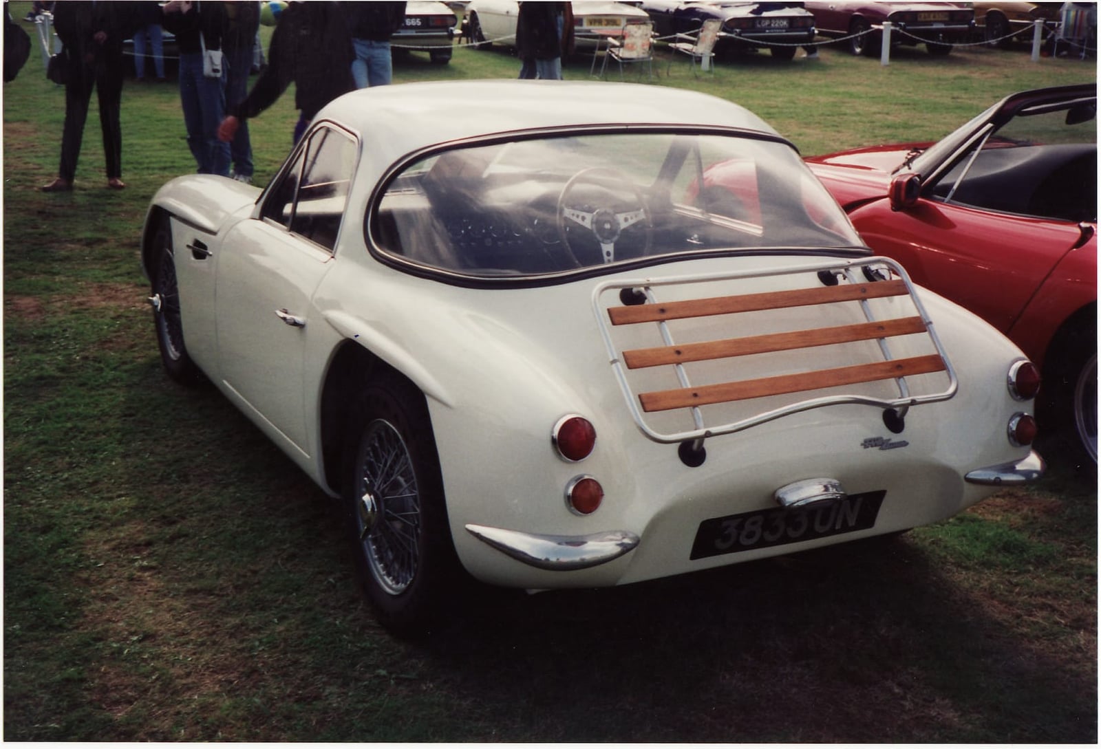 The rear view of a cream 1962 TVR Grantura showing the luggage rack and cut-off tail