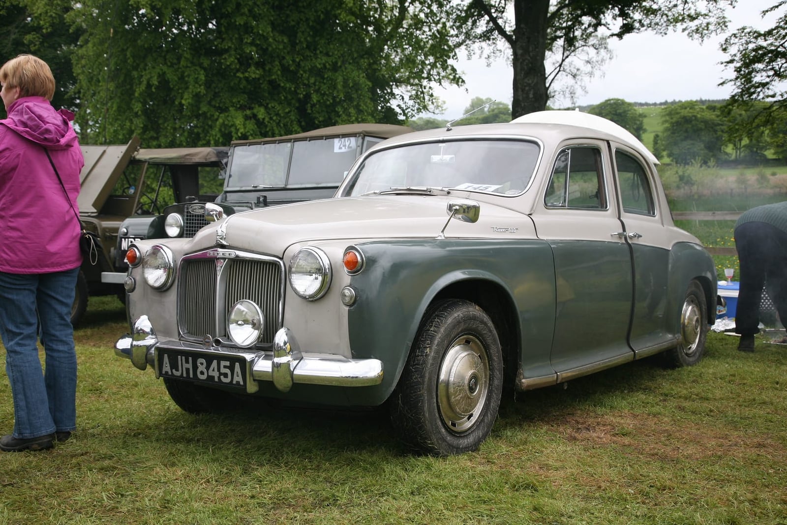 A two-tone grey and green 1963 Rover P4 110 on grass at a classic vehicle rally, UK registration AJH 845A