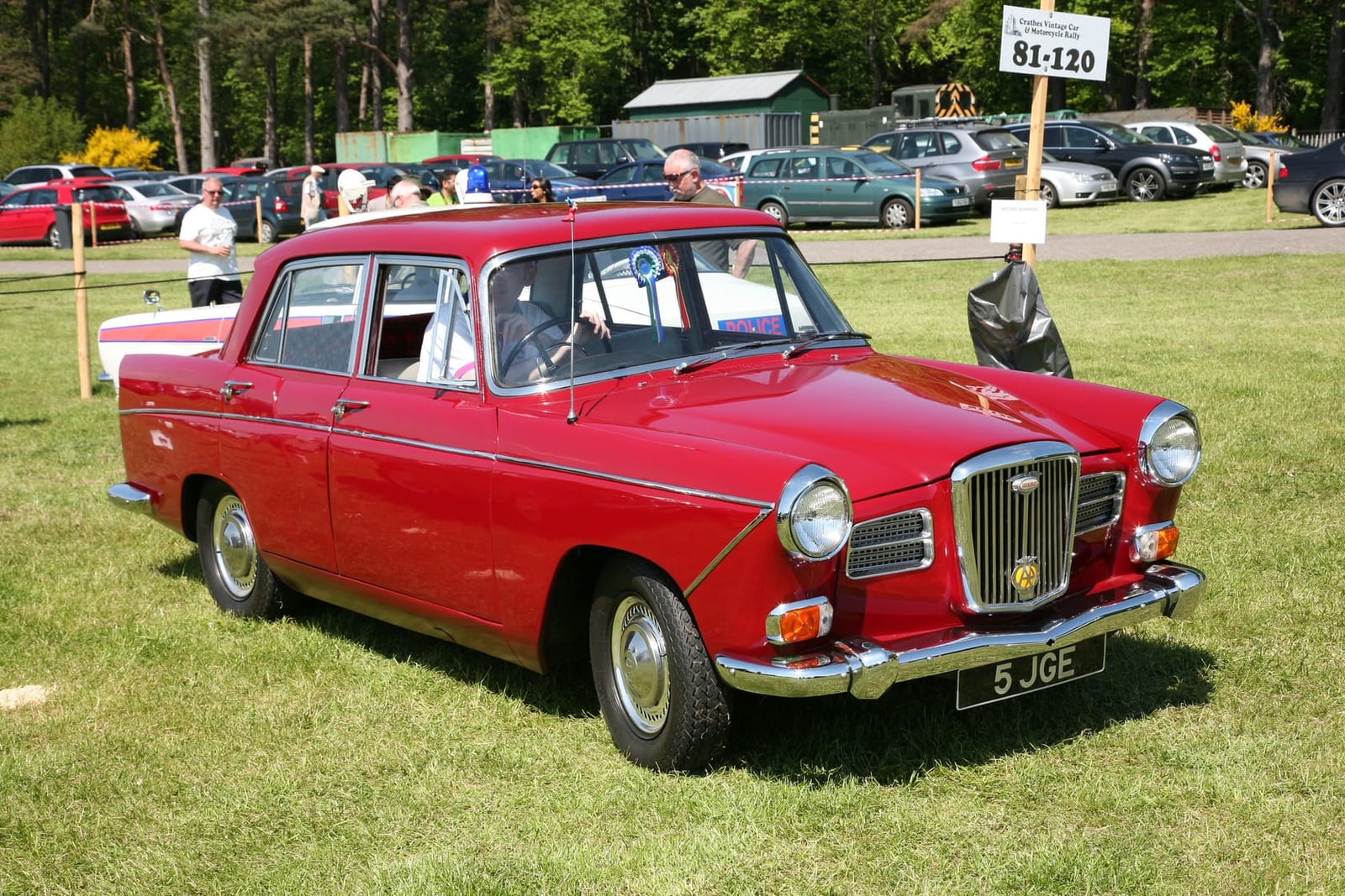 A red 1963 Wolseley 16/60 saloon at a classic car show