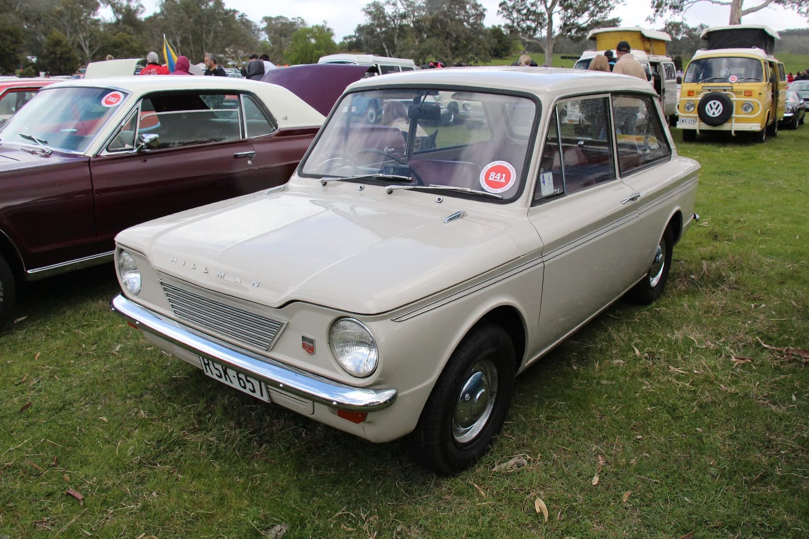 A white 1964 Hillman Imp Mk I at a classic car show, front three-quarter view