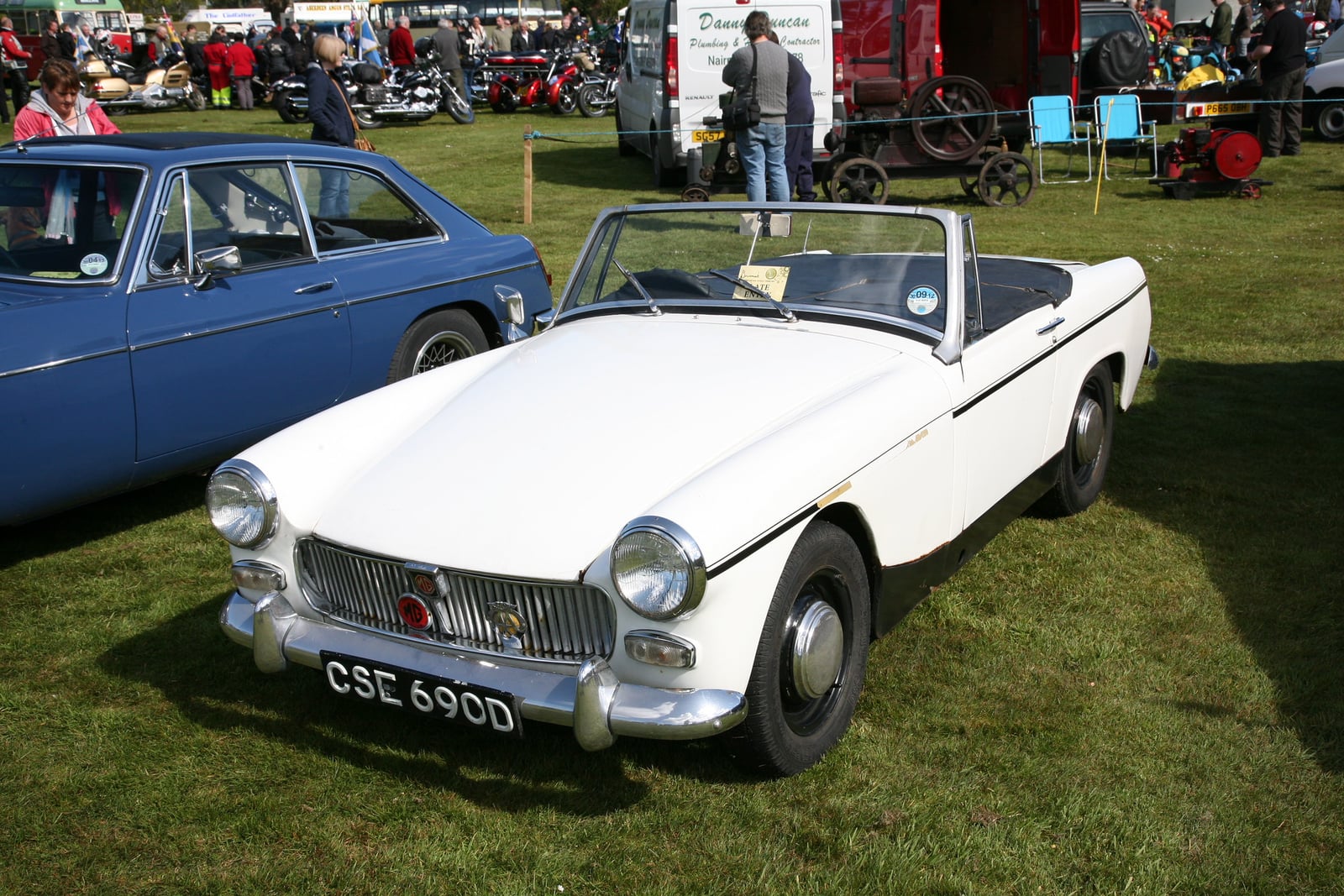 A white MG Midget, front three-quarter view at a show