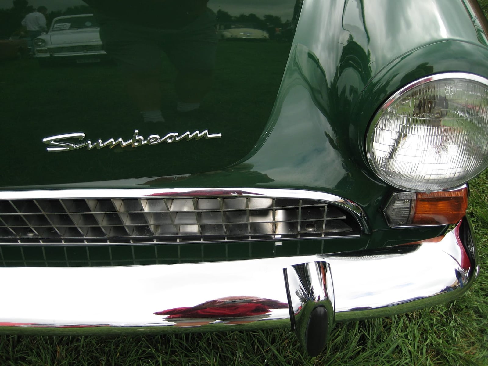 Front detail of a dark green 1967 Sunbeam Tiger Mk II showing the eggcrate grille and Sunbeam script