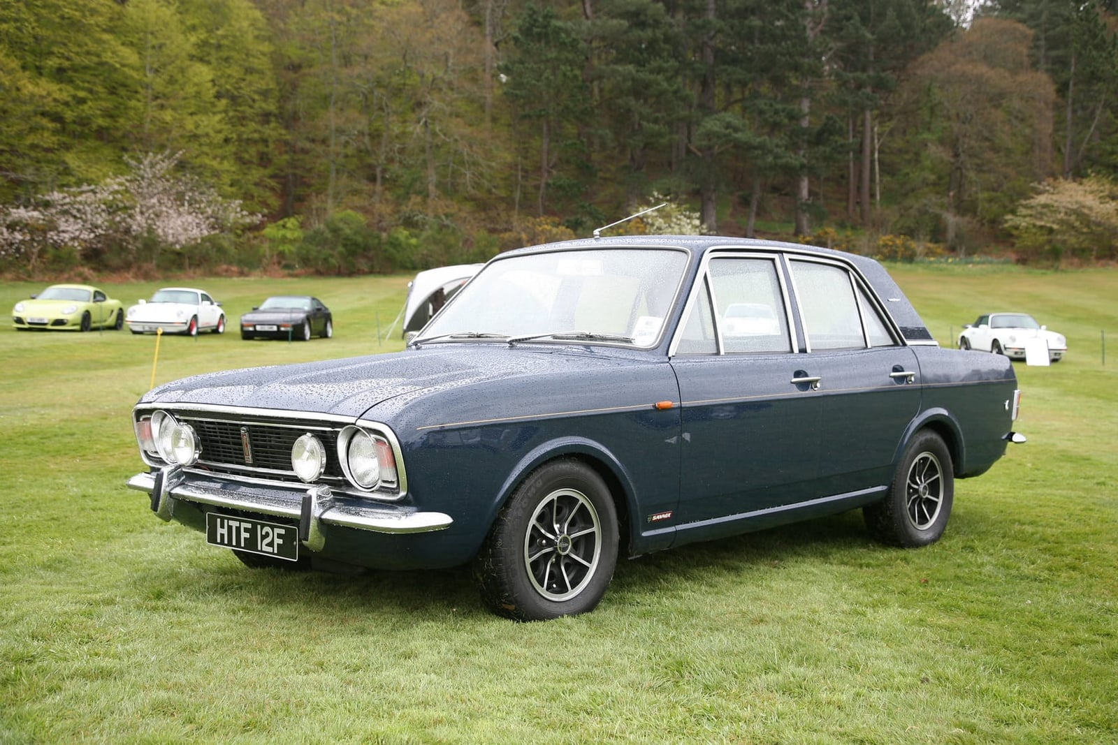 A dark blue 1968 Ford Cortina Savage with a UK registration on grass at a show