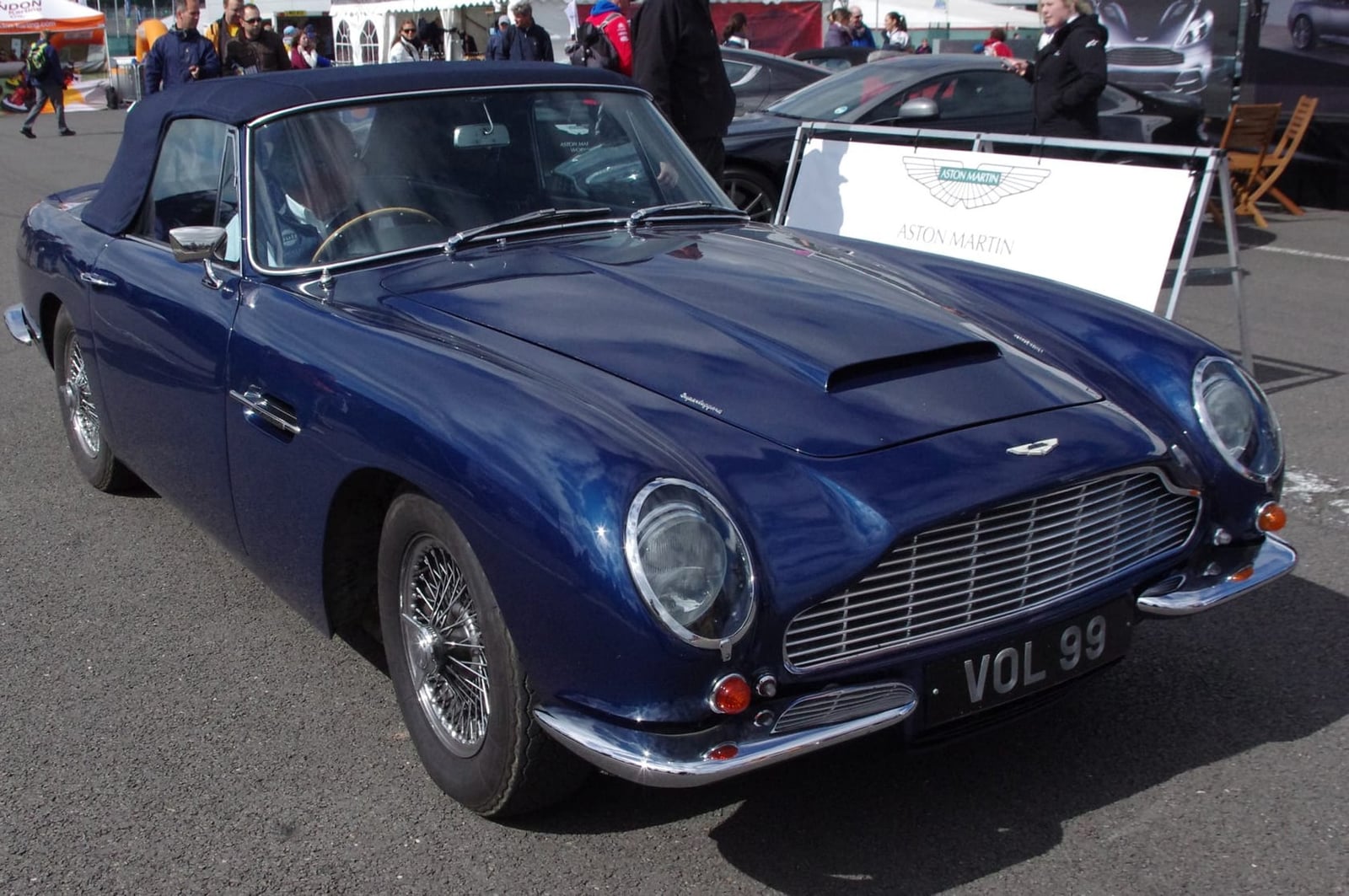 A dark blue 1969 Aston Martin DB6 Volante with UK registration VOL 99 at a classic show
