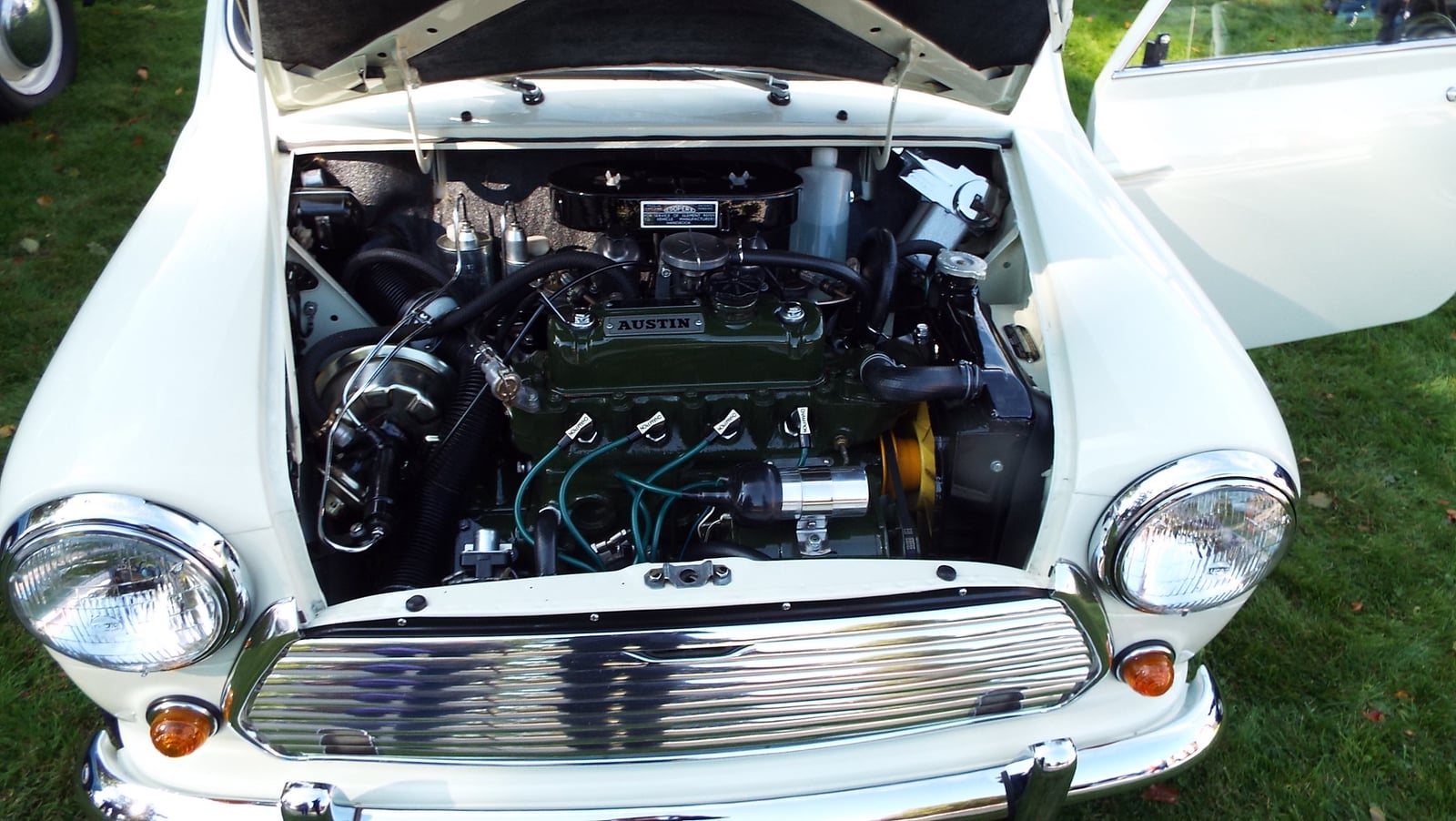 The engine bay of a classic Austin Mini, the BMC A-series four-cylinder engine mounted sideways across the car with the radiator on the left