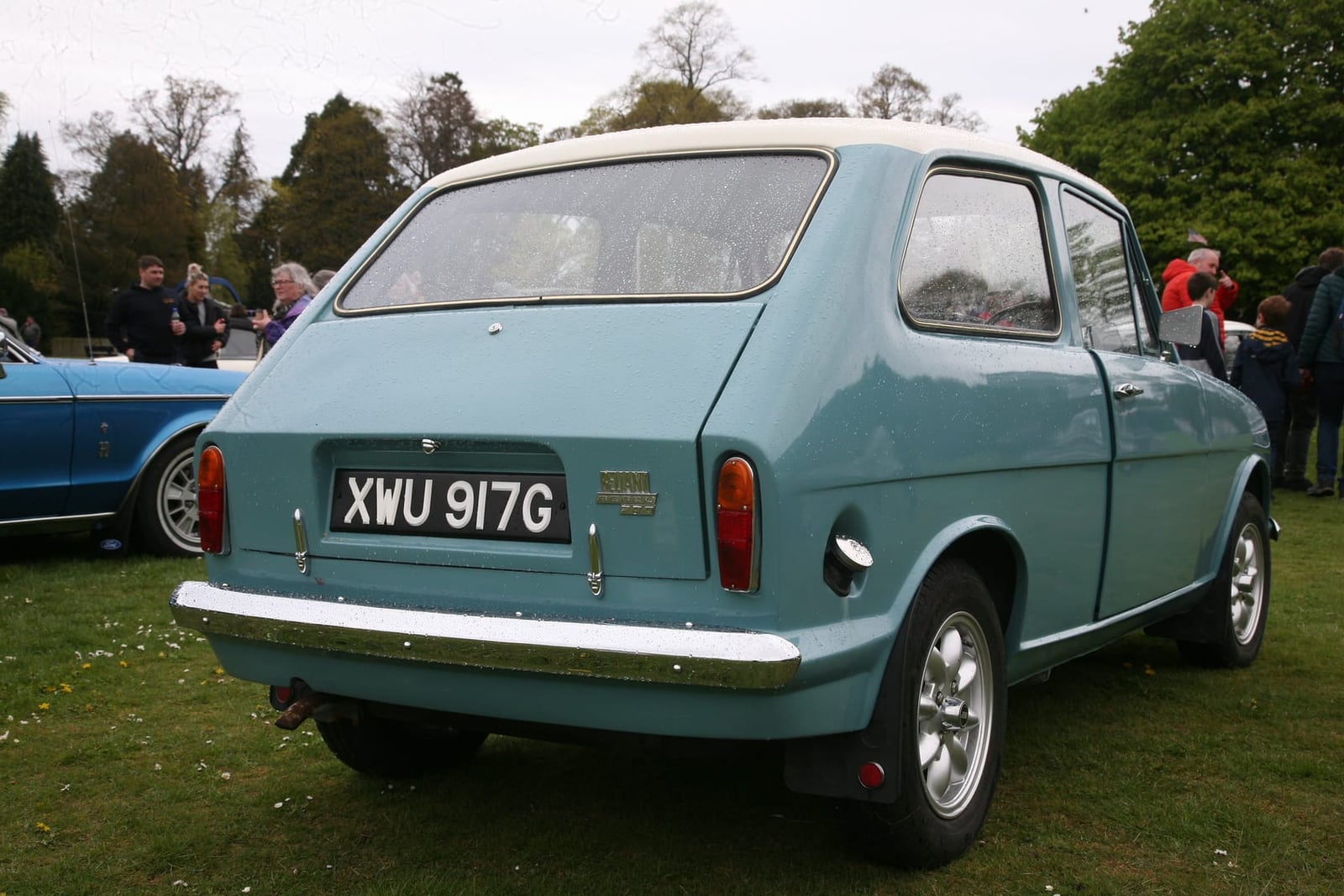 The rear three-quarter of a light blue 1969 Reliant Rebel 700 at a show, UK registration XWU 917G