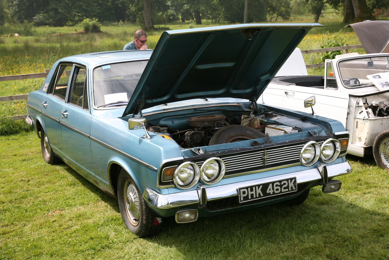 A pale blue Ford Zodiac Mk4 Executive with the bonnet raised, showing the V6 engine