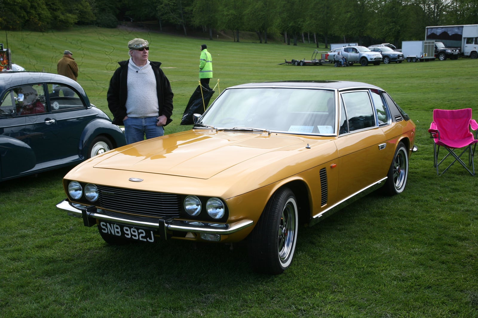A gold Jensen Interceptor at a show, front three-quarter view