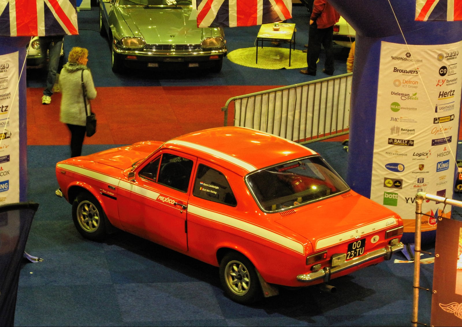 An orange Mk1 Ford Escort Mexico on display, front three-quarter view