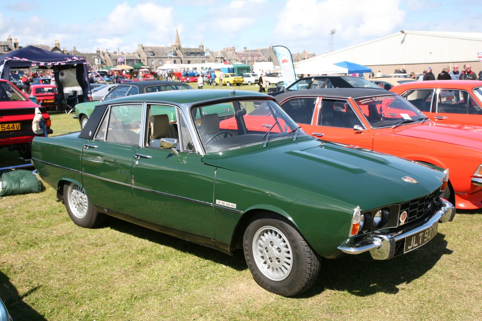 A green Rover P6 3500 automatic on grass at a classic car show, front three-quarter view