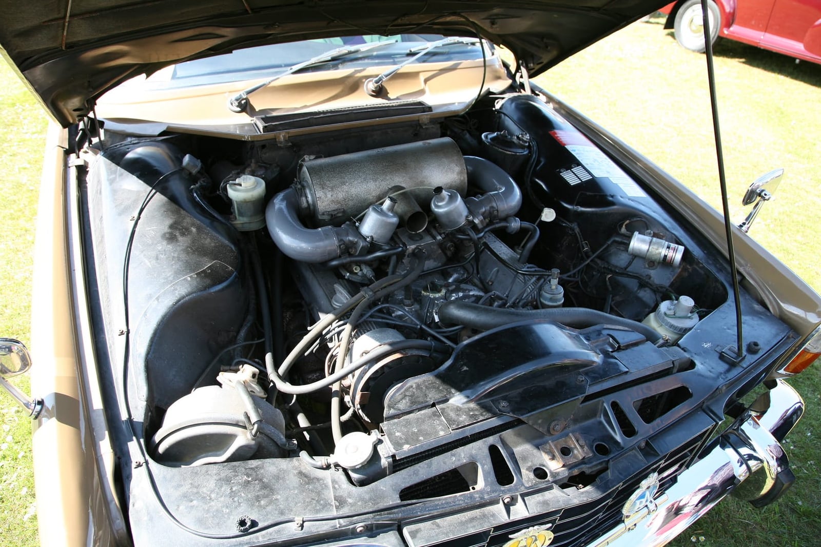 The engine bay of a Rover P6 3500 showing the aluminium V8 and its twin air cleaners