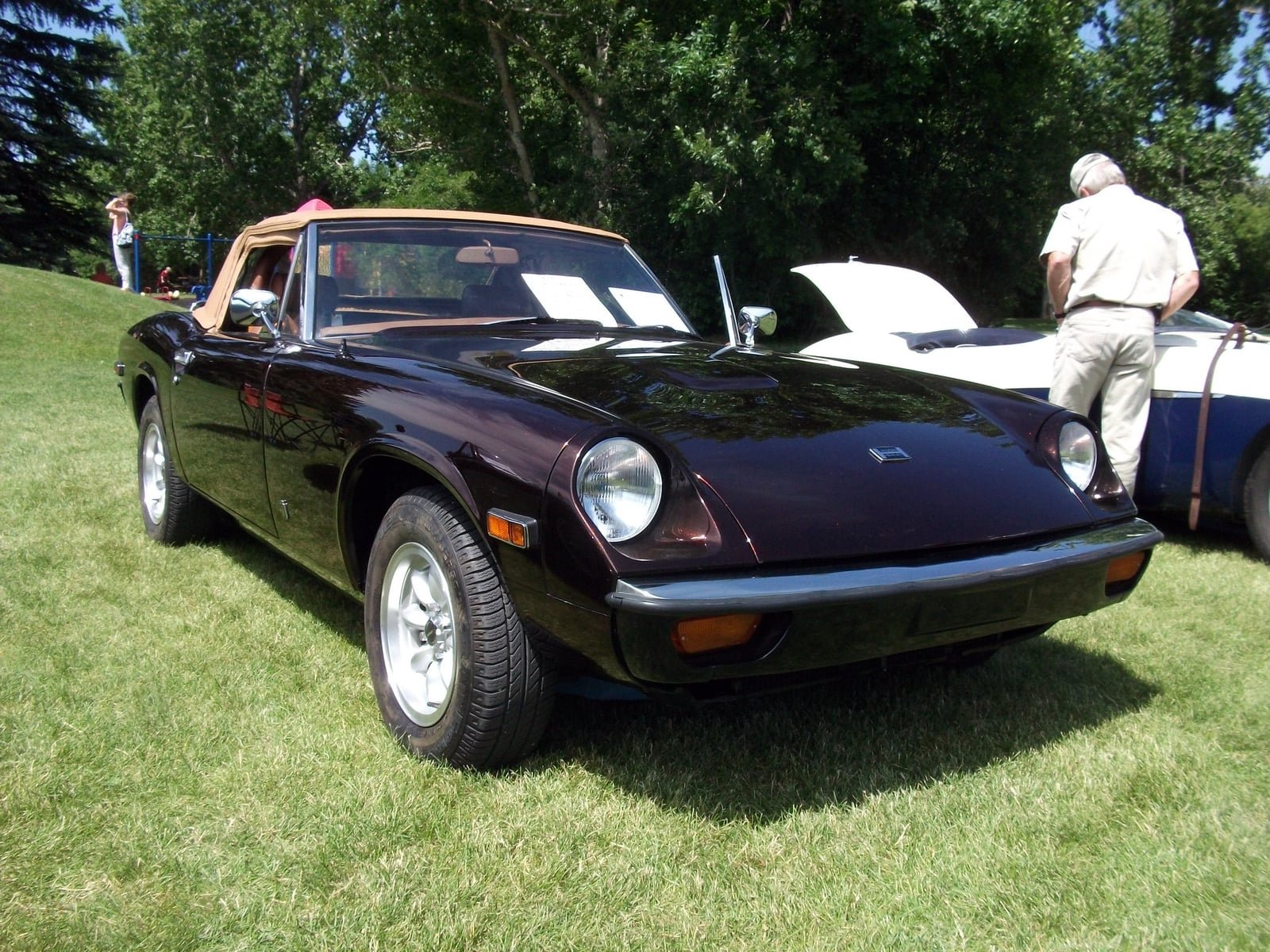 A dark blue Jensen-Healey roadster at a show, front three-quarter view