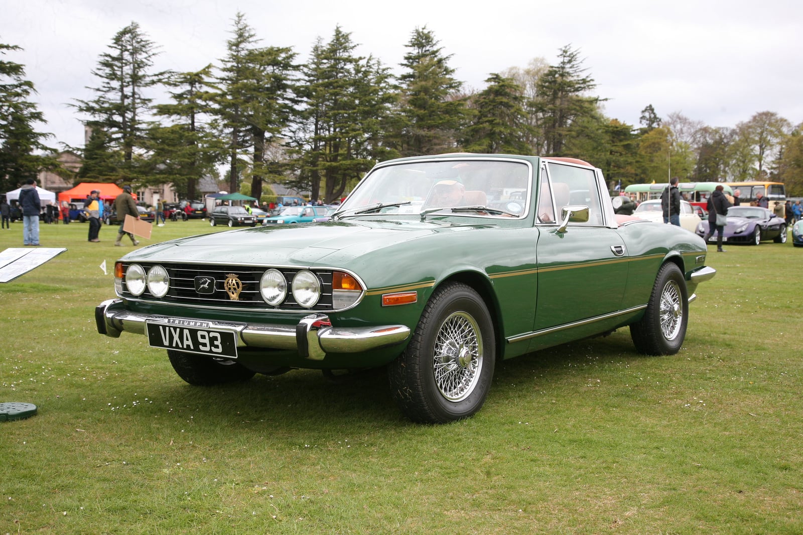 A white Triumph Stag with its hardtop fitted, front three-quarter view on grass