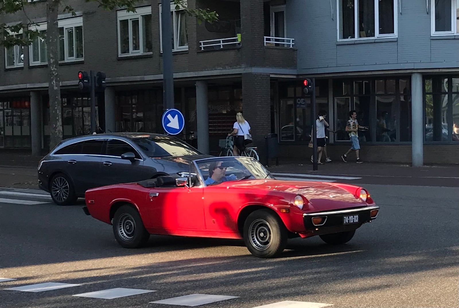 A red Jensen-Healey 2.0 on a cobbled street, front three-quarter view