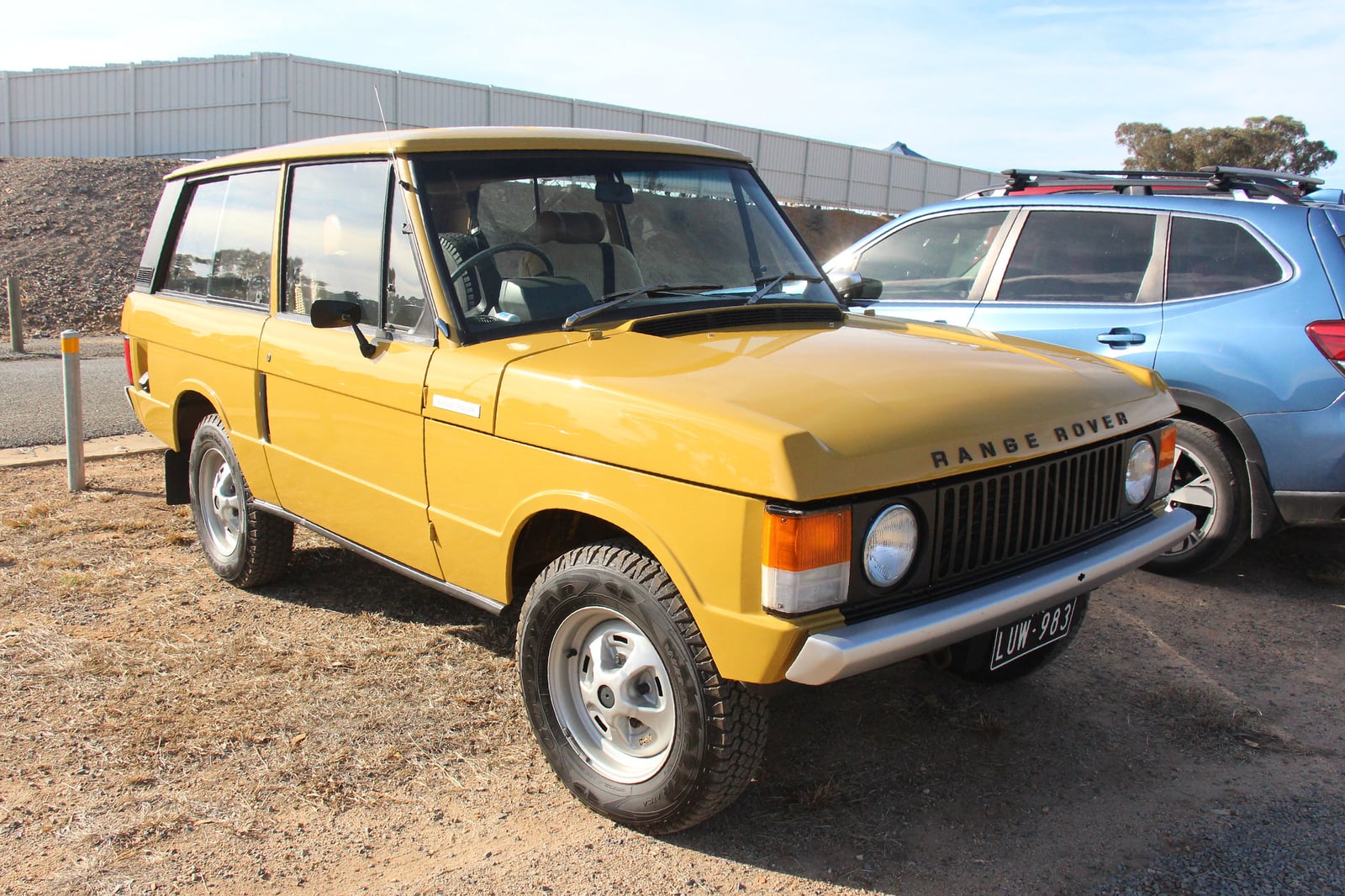 A gold early two-door Range Rover Classic