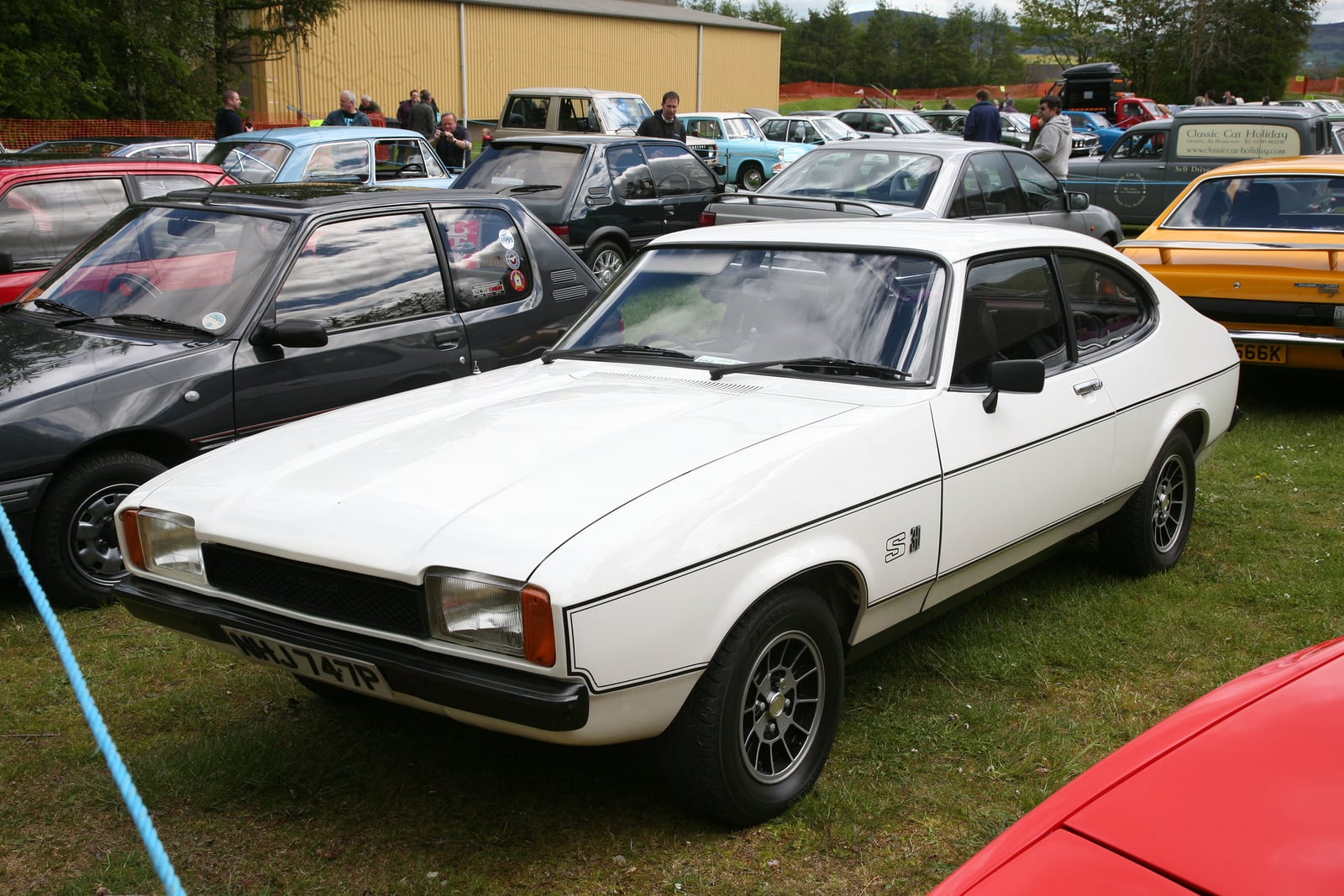A beige Ford Capri 3.0S Mk3, front three-quarter view at a show