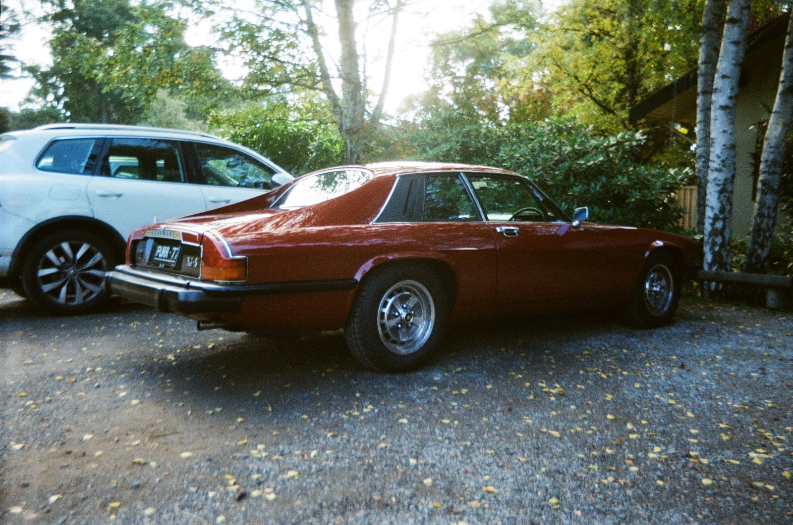 A copper-brown Jaguar XJ-S pre-HE coupe from 1977, rear three-quarter view