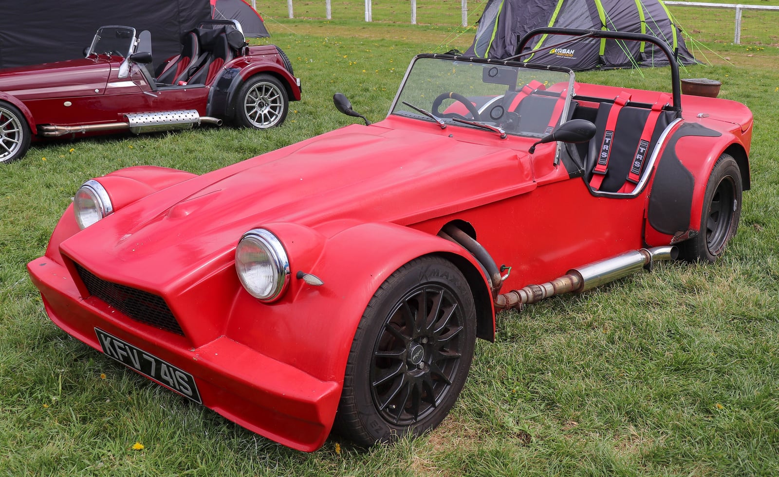A red 1978 Dutton Phaeton cycle-winged roadster, front view