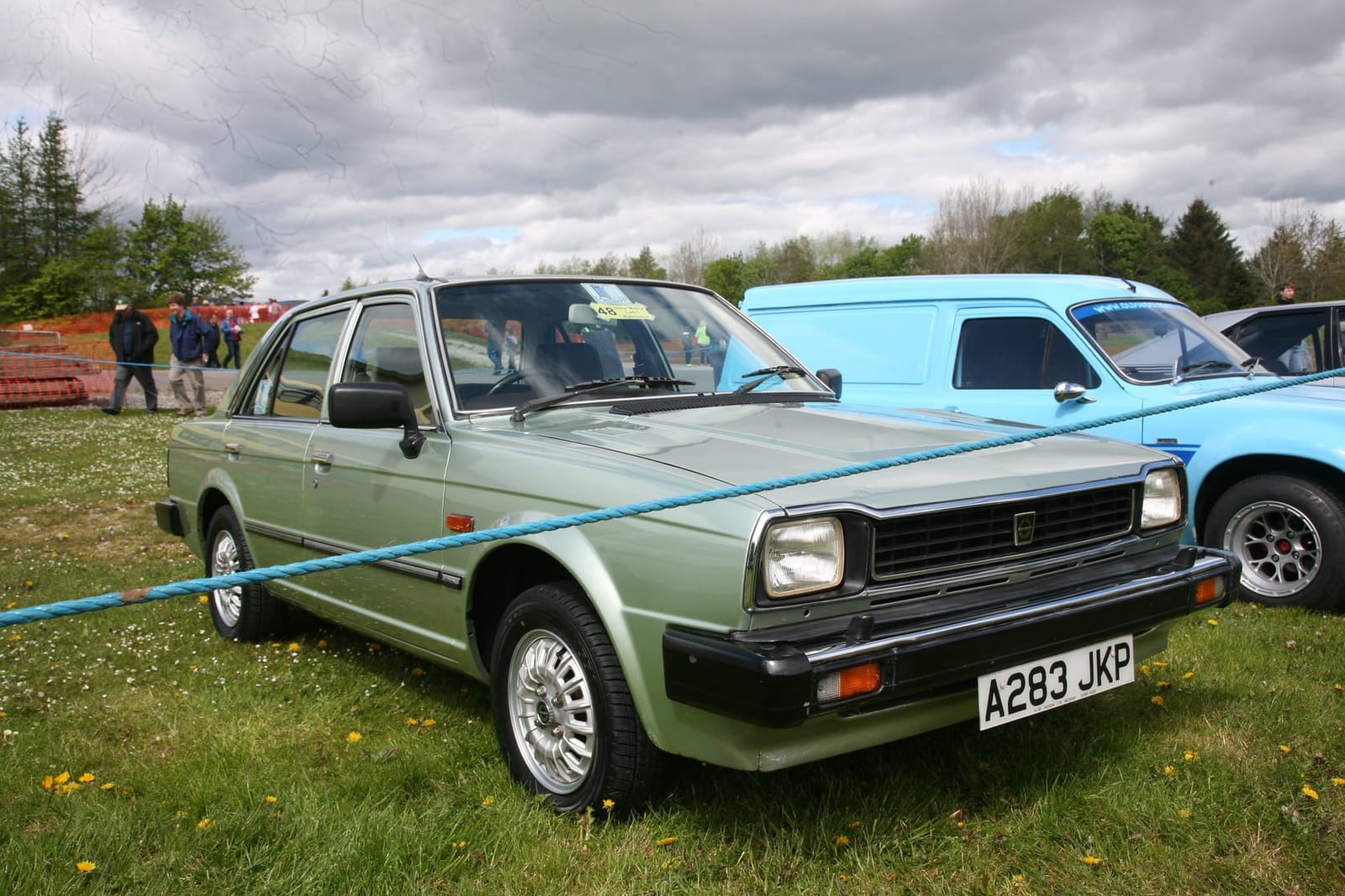 A silver-green 1984 Triumph Acclaim CD at a classic car show, front three-quarter view, UK registration A283 JKP