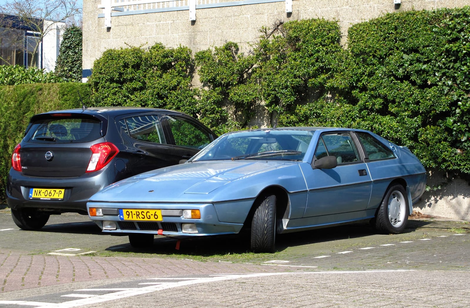 A red Lotus Excel on grass at a classic car show, front three-quarter view, UK registration E750 KHX