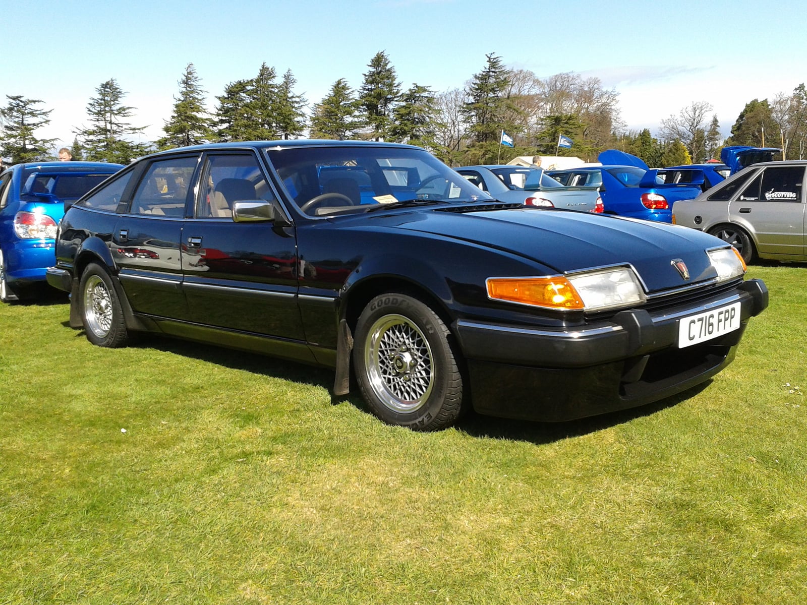 A black Rover SD1 fastback saloon, front three-quarter view, on grass at a show