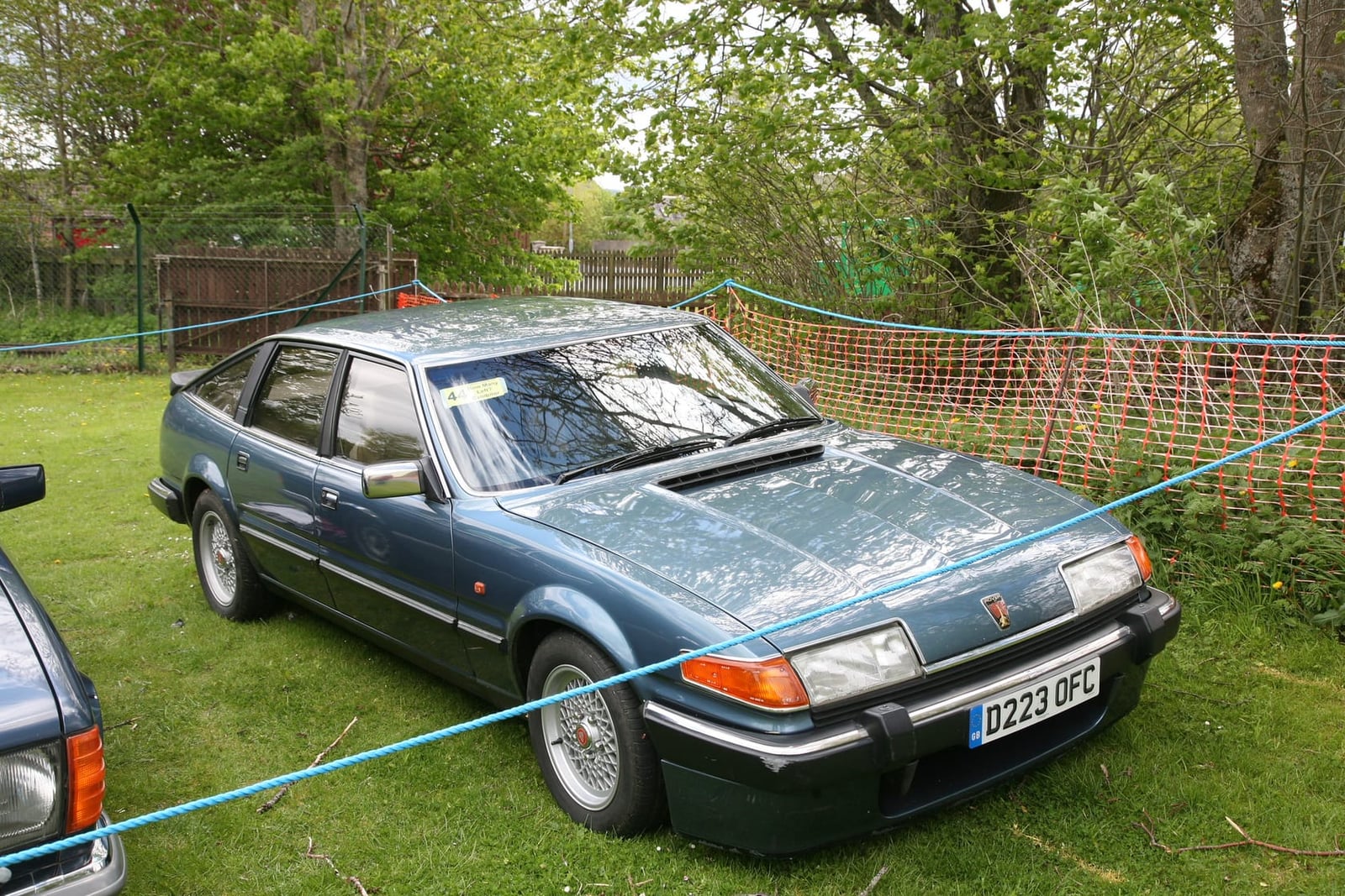 A blue-grey 1986 Rover SD1 Vitesse at a classic car show, front three-quarter view, UK registration D223 OFG