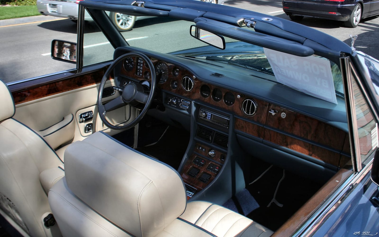 The cream leather and burr walnut interior of a 1987 Rolls-Royce Corniche II convertible