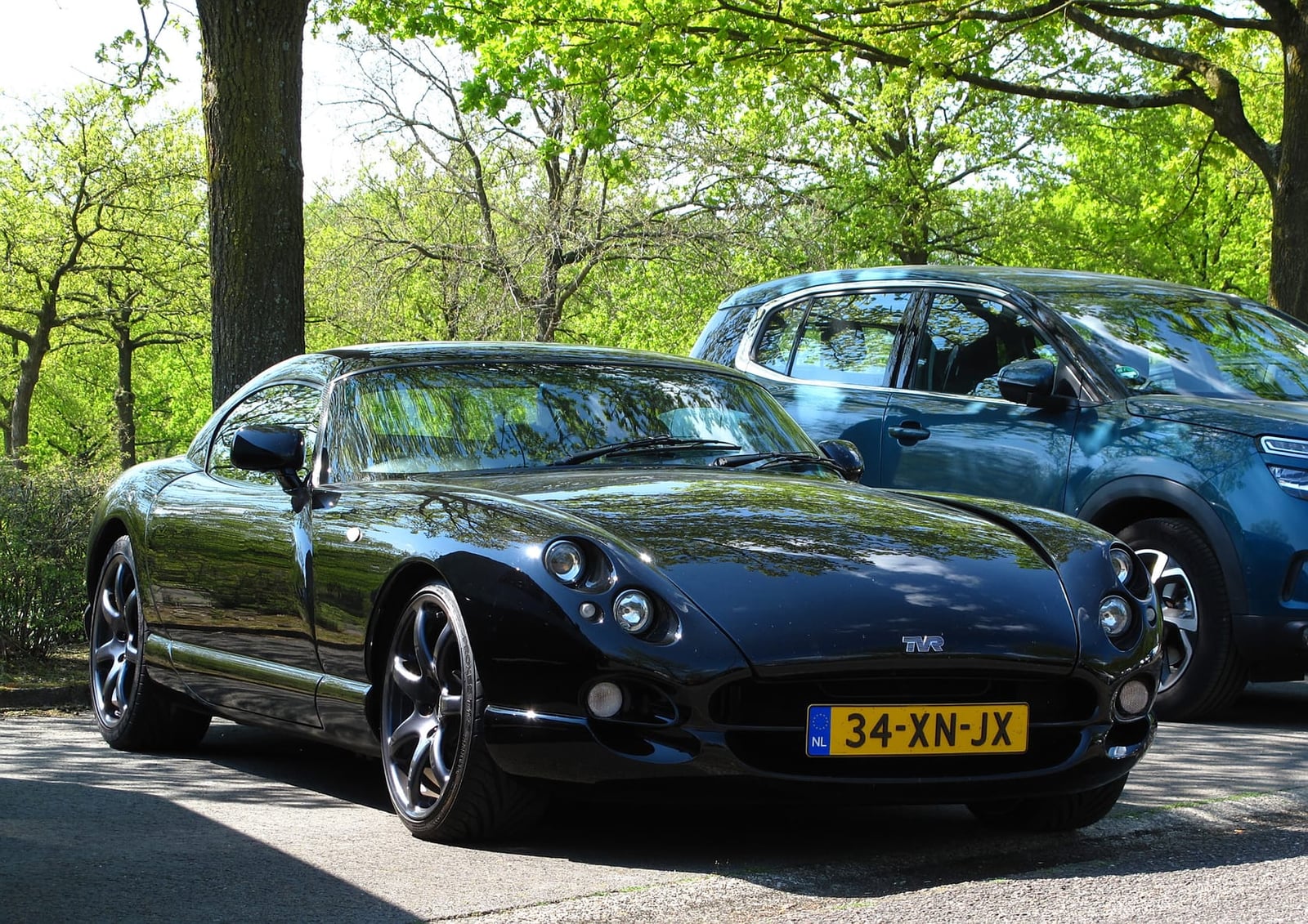 A black 1998 TVR Cerbera 4.2 V8 front three-quarter view under trees