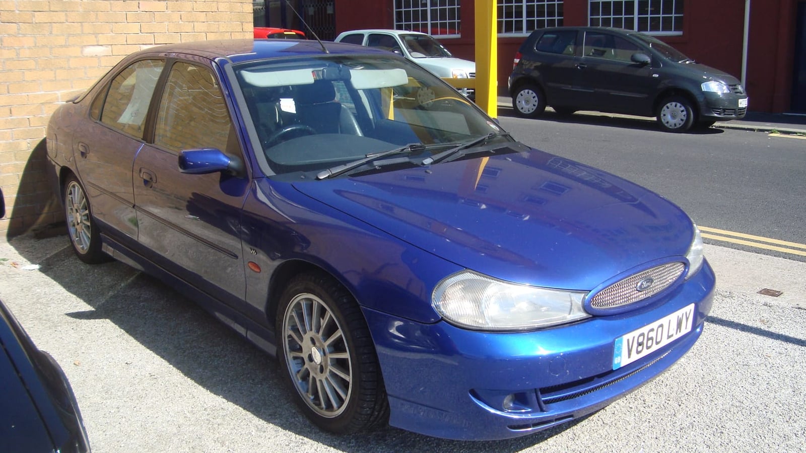 A 1999 Ford Mondeo ST200 hatchback in Imperial Blue with UK registration, parked on a street