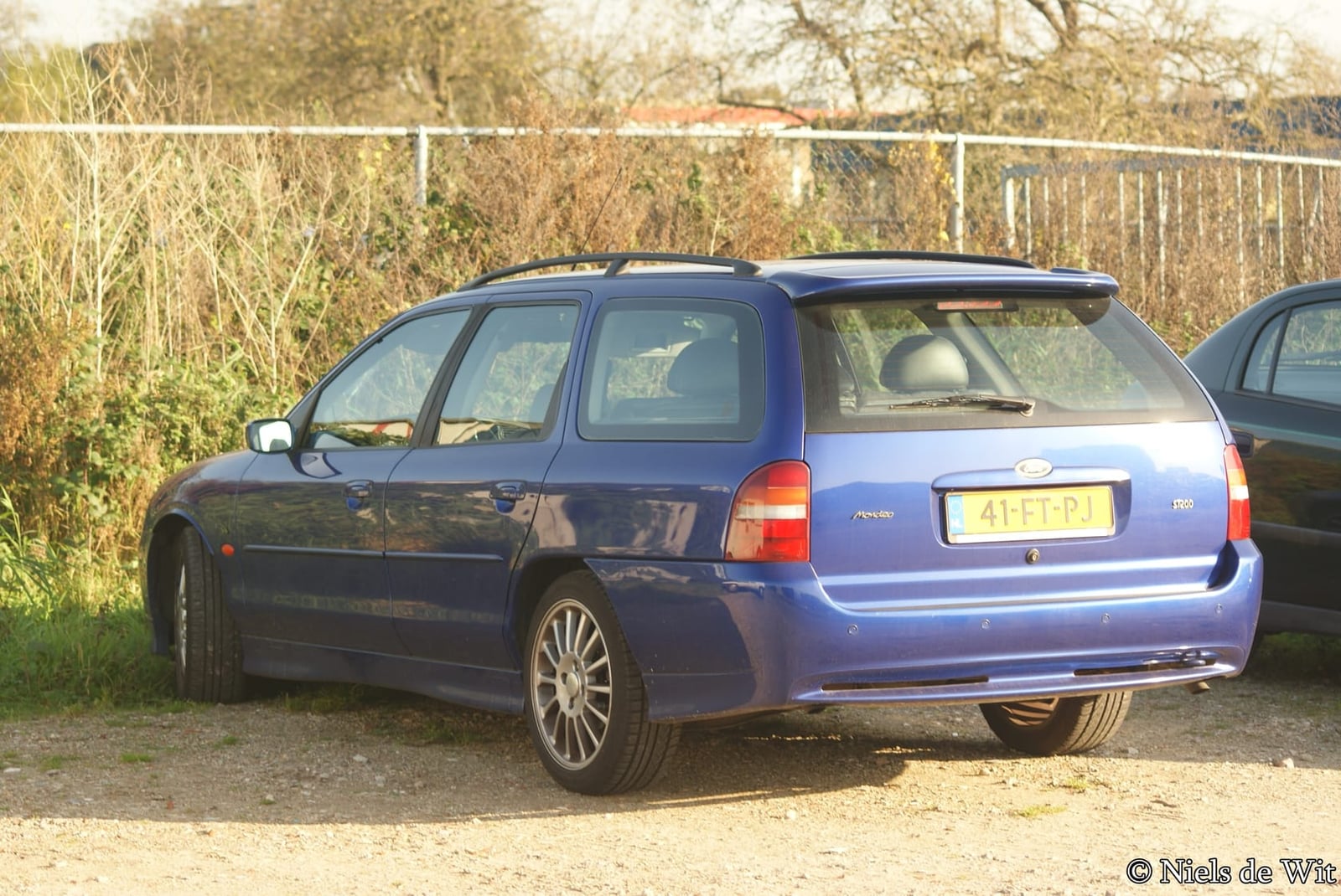 A 2000 Ford Mondeo ST200 estate in Imperial Blue with UK registration, rear three-quarter view