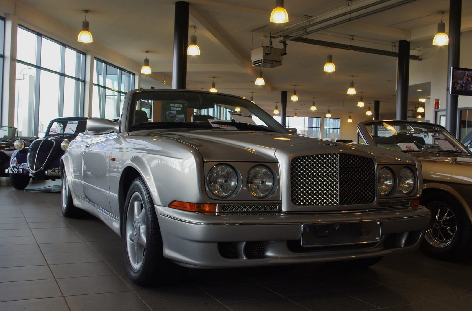 A silver 2001 Bentley Continental with Mulliner mesh grille in a showroom