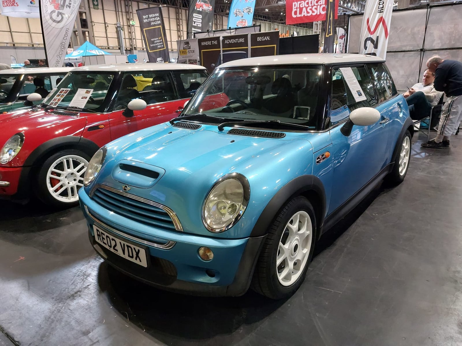 A blue 2002 MINI Cooper S R53 with a UK registration displayed at the NEC classic car restoration show