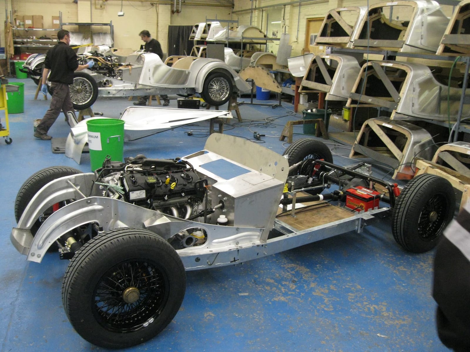 Bare Morgan chassis and body frames lined up on trolleys inside the Malvern factory