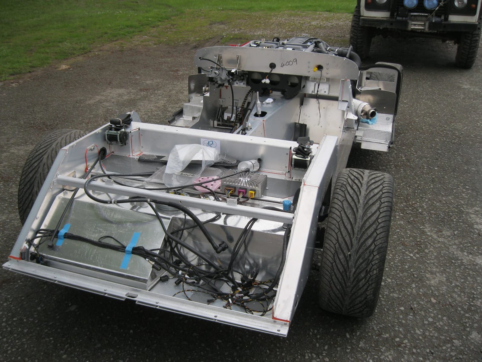 A 2012 Morgan Plus 8 bonded aluminium running chassis seen from the rear, showing suspension and exhaust