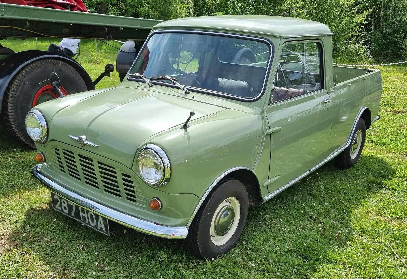 A green Mini Pick-up at a show, front three-quarter view