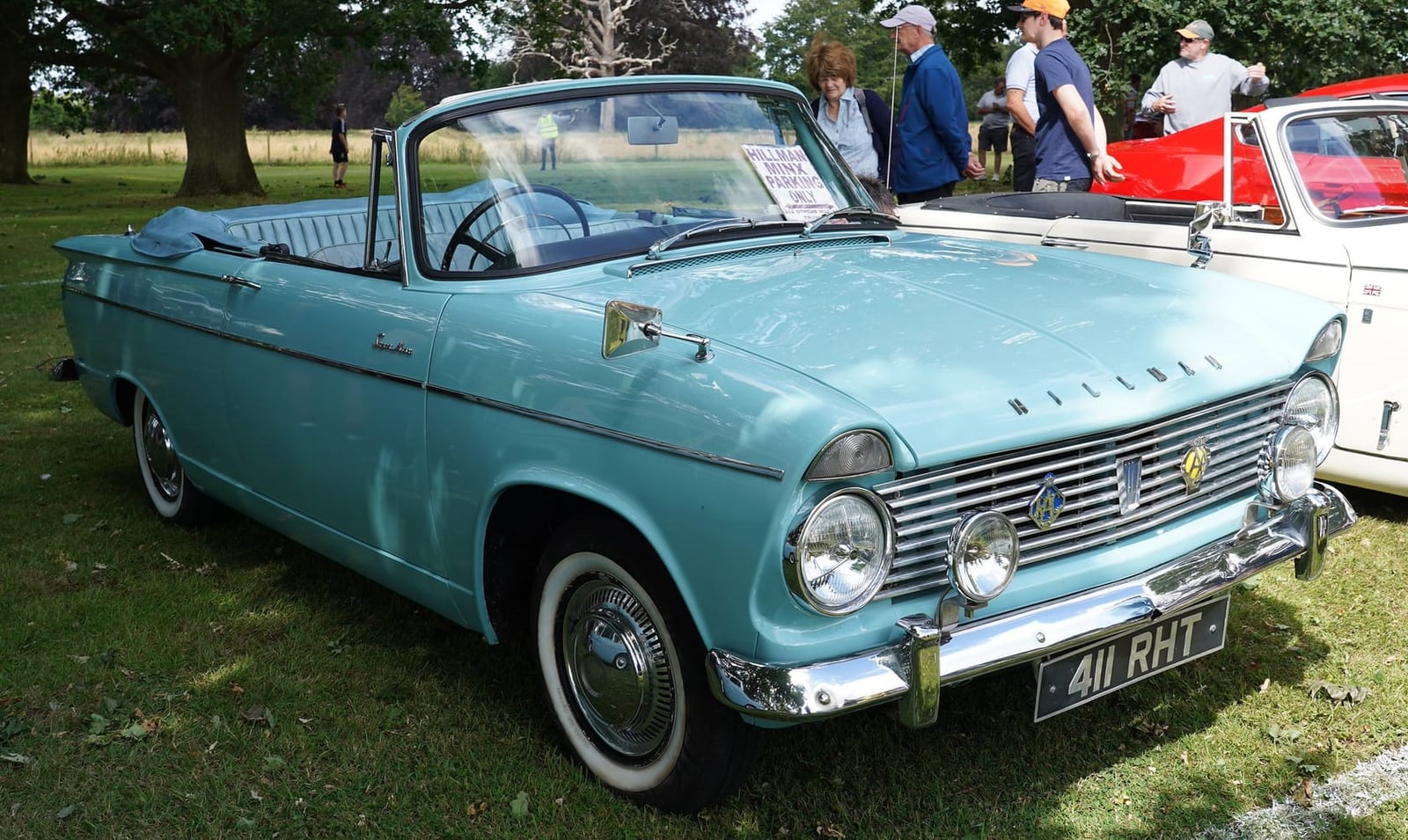 A light blue 1962 Hillman Minx convertible with the hood down, UK registration 411 RHT