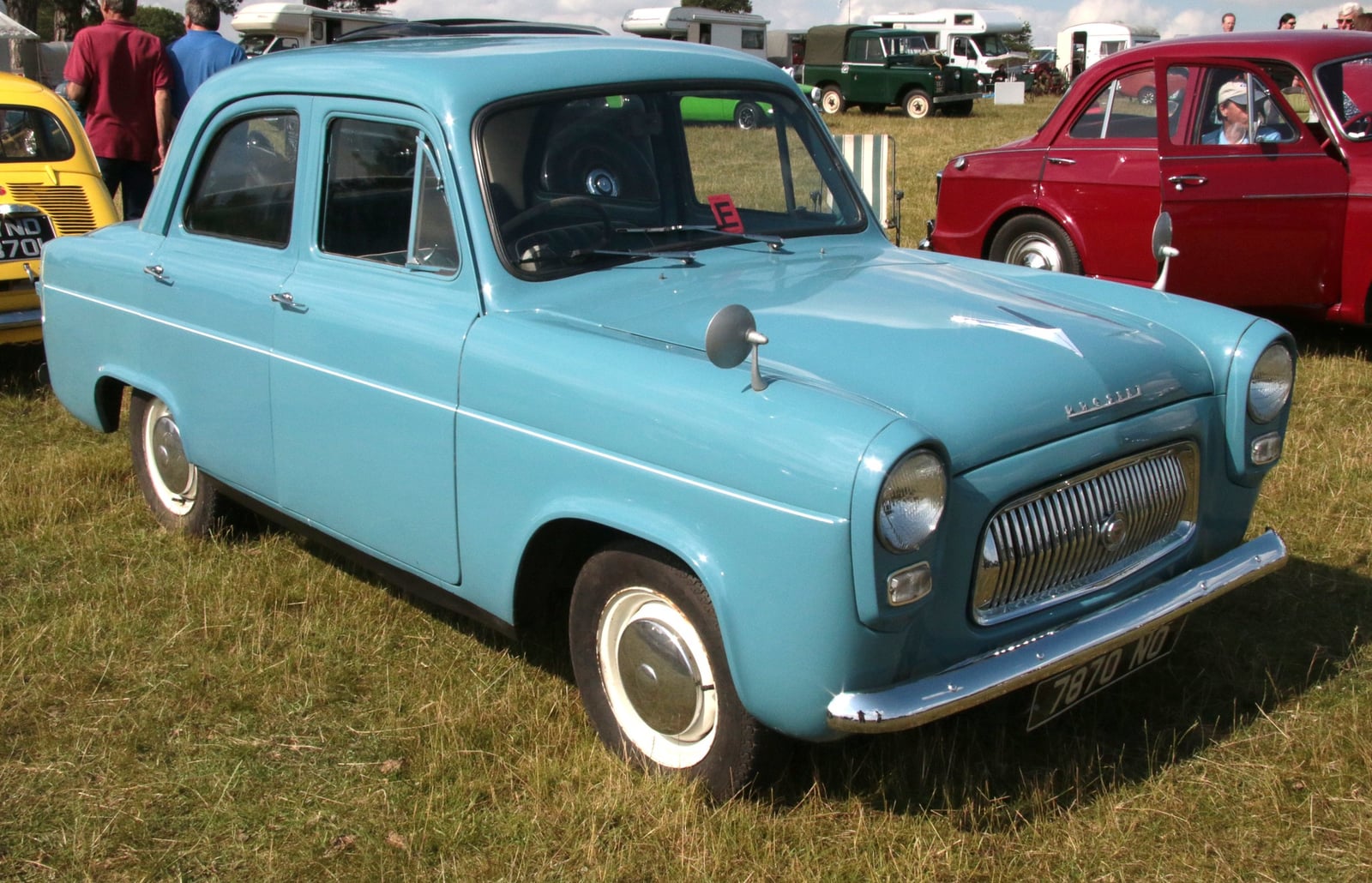 A light blue Ford Prefect 100E saloon at a show, front three-quarter view