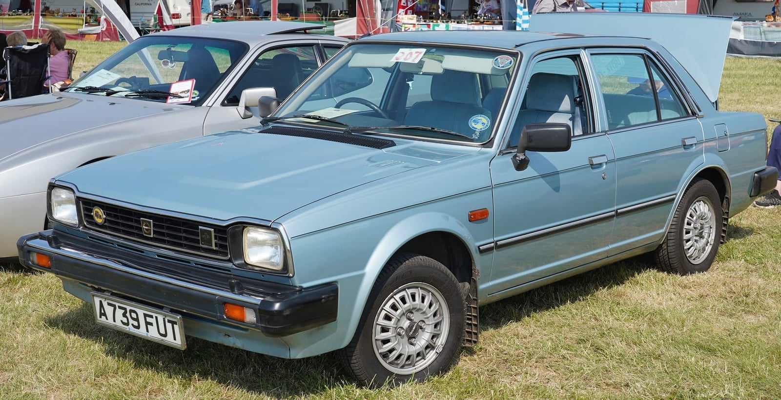 A light blue Triumph Acclaim at a classic car show, front three-quarter view, UK registration A739 FUT