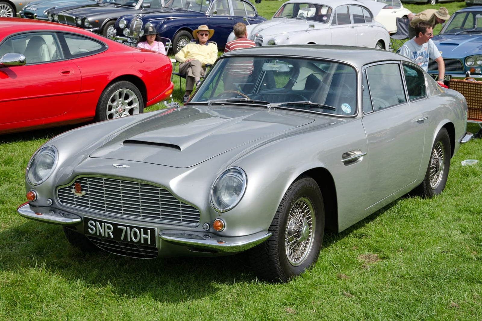 A silver 1969 Aston Martin DB6 Mk2 with UK registration SNR 710H at a show field
