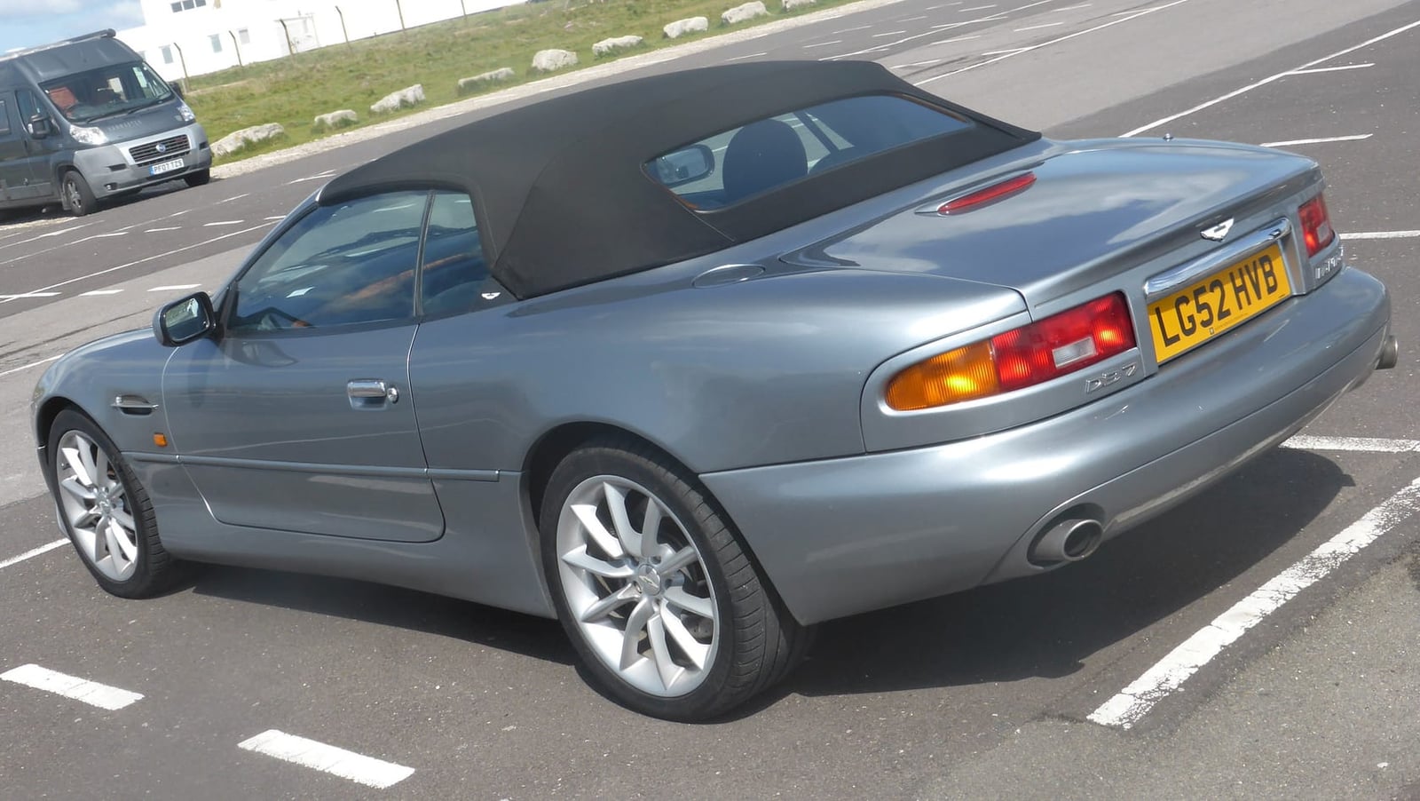 A grey Aston Martin DB7 Volante with the roof up and UK registration L52 AHE