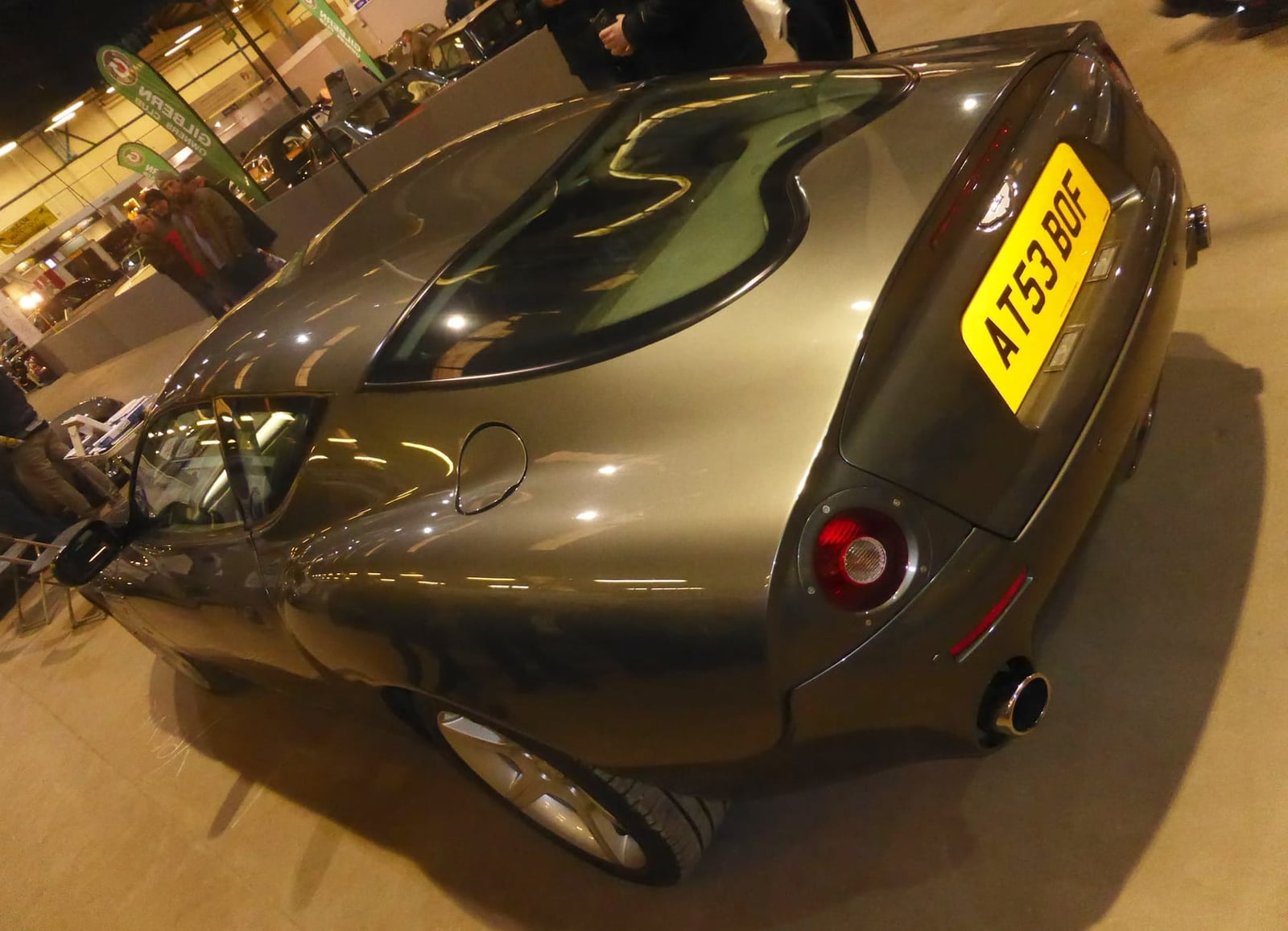 The rear of a grey 2004 Aston Martin DB7 Zagato at an indoor show
