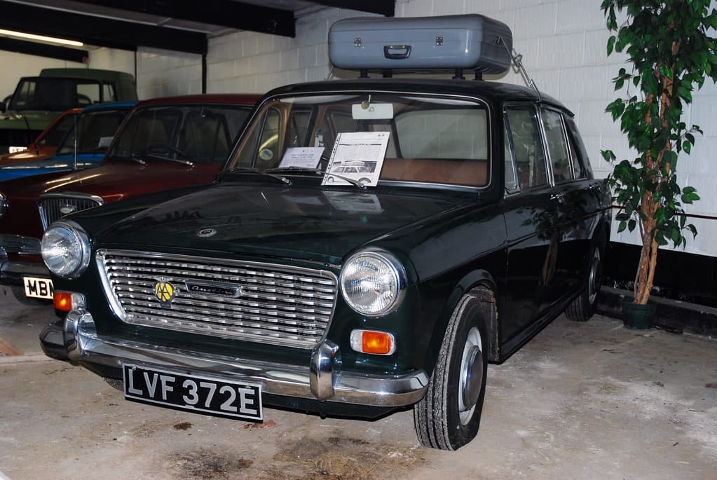 A dark green Austin 1100 on indoor museum display, front three-quarter view, UK registration LVF 372E