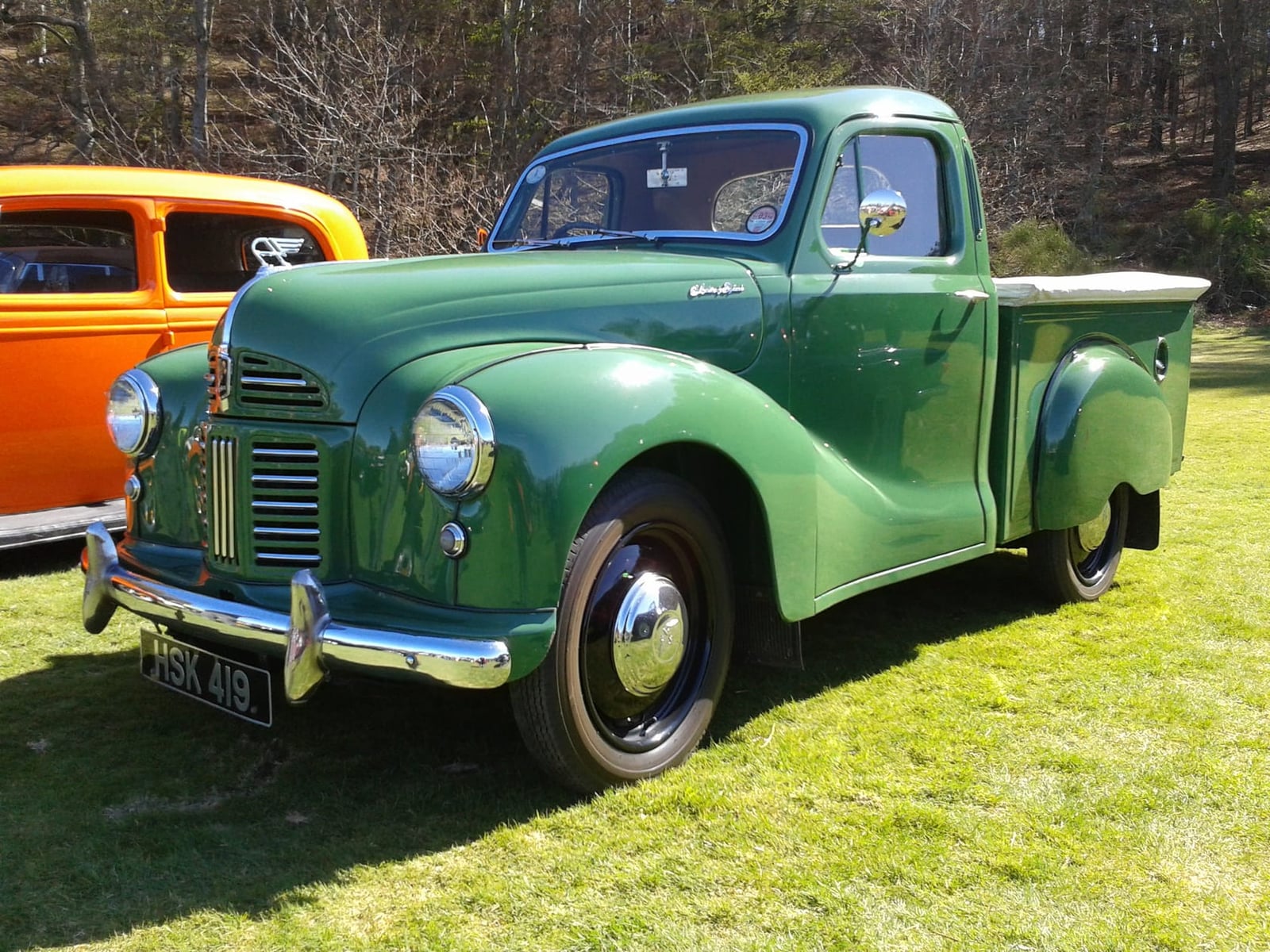 A green Austin A40 Devon pick-up truck at an outdoor classic vehicle show