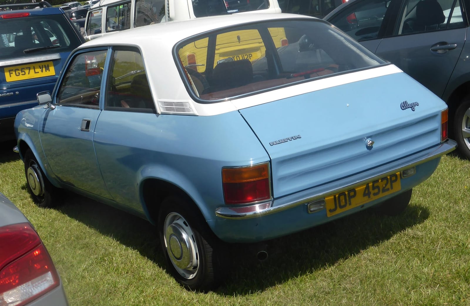 A light blue 1975 Austin Allegro 1100 two-door with a white vinyl roof, rear three-quarter view