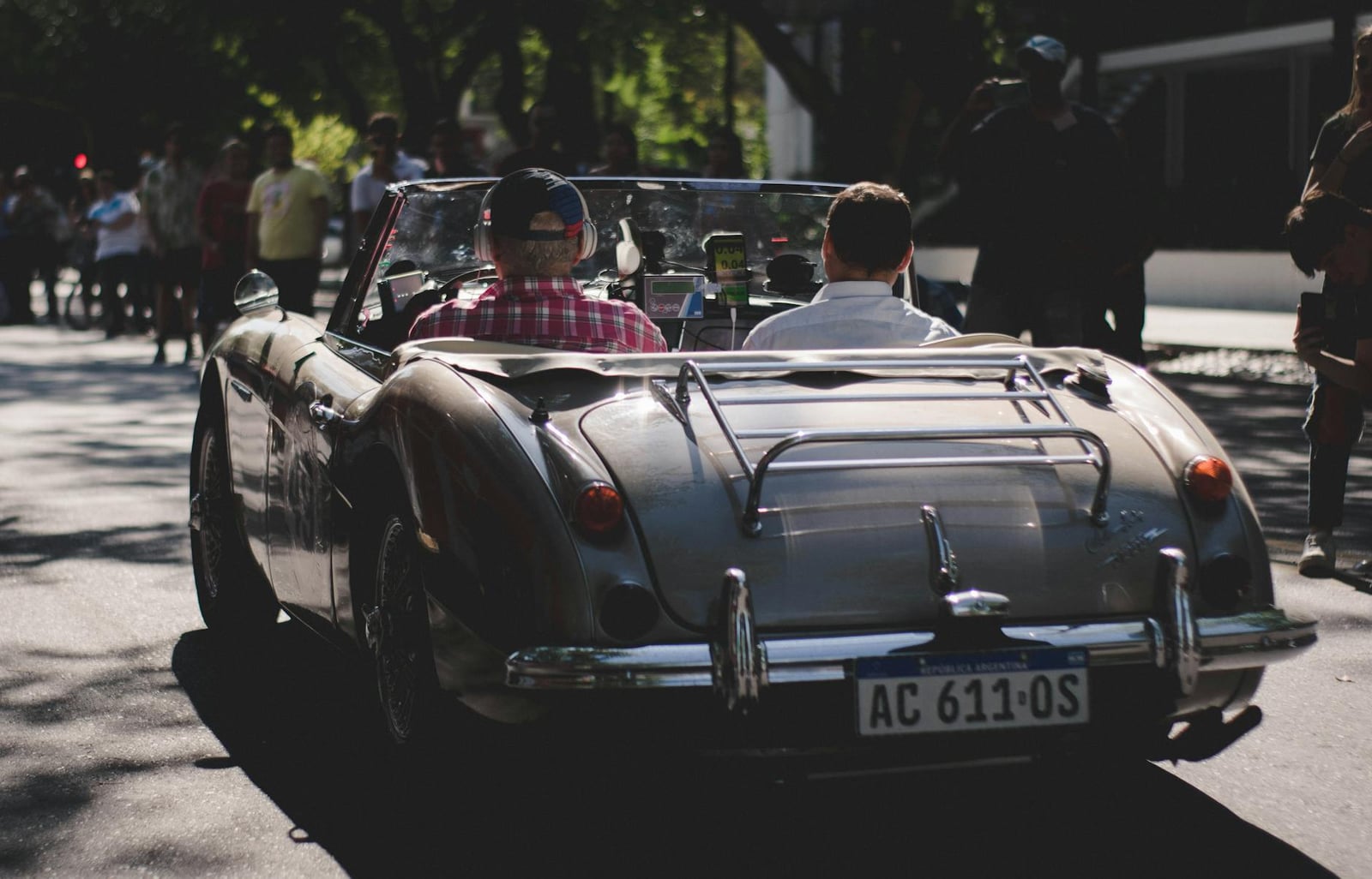 A silver Austin-Healey 3000 with two crew on a classic-car rally