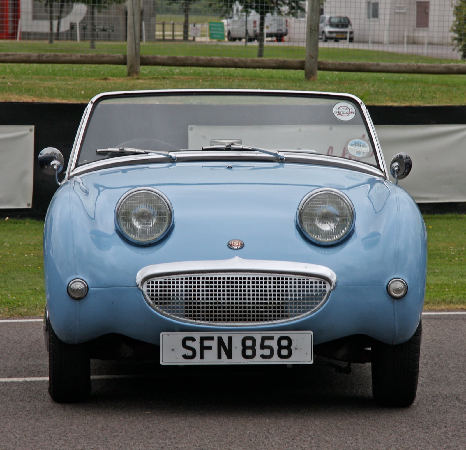 A light blue Austin-Healey Frogeye Sprite, front three-quarter view, with a UK number plate