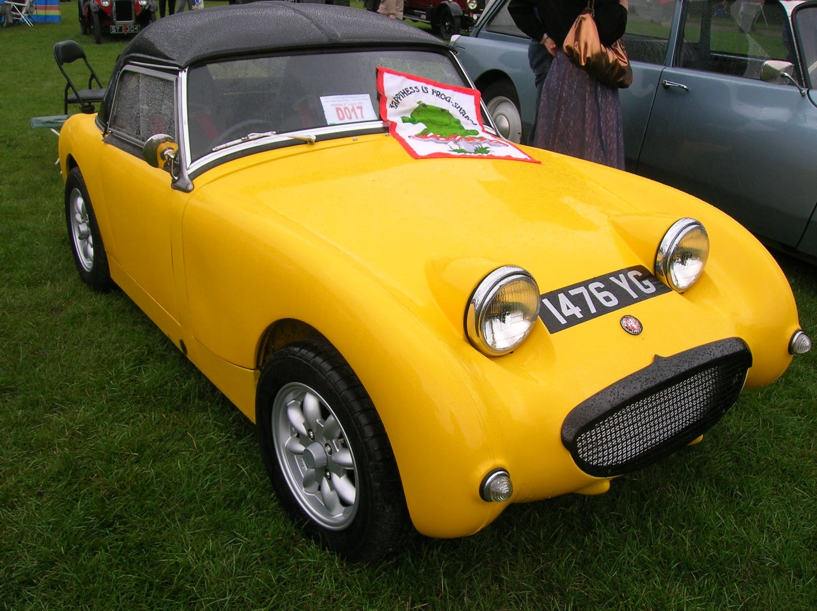 A yellow Austin-Healey Frogeye Sprite at a show