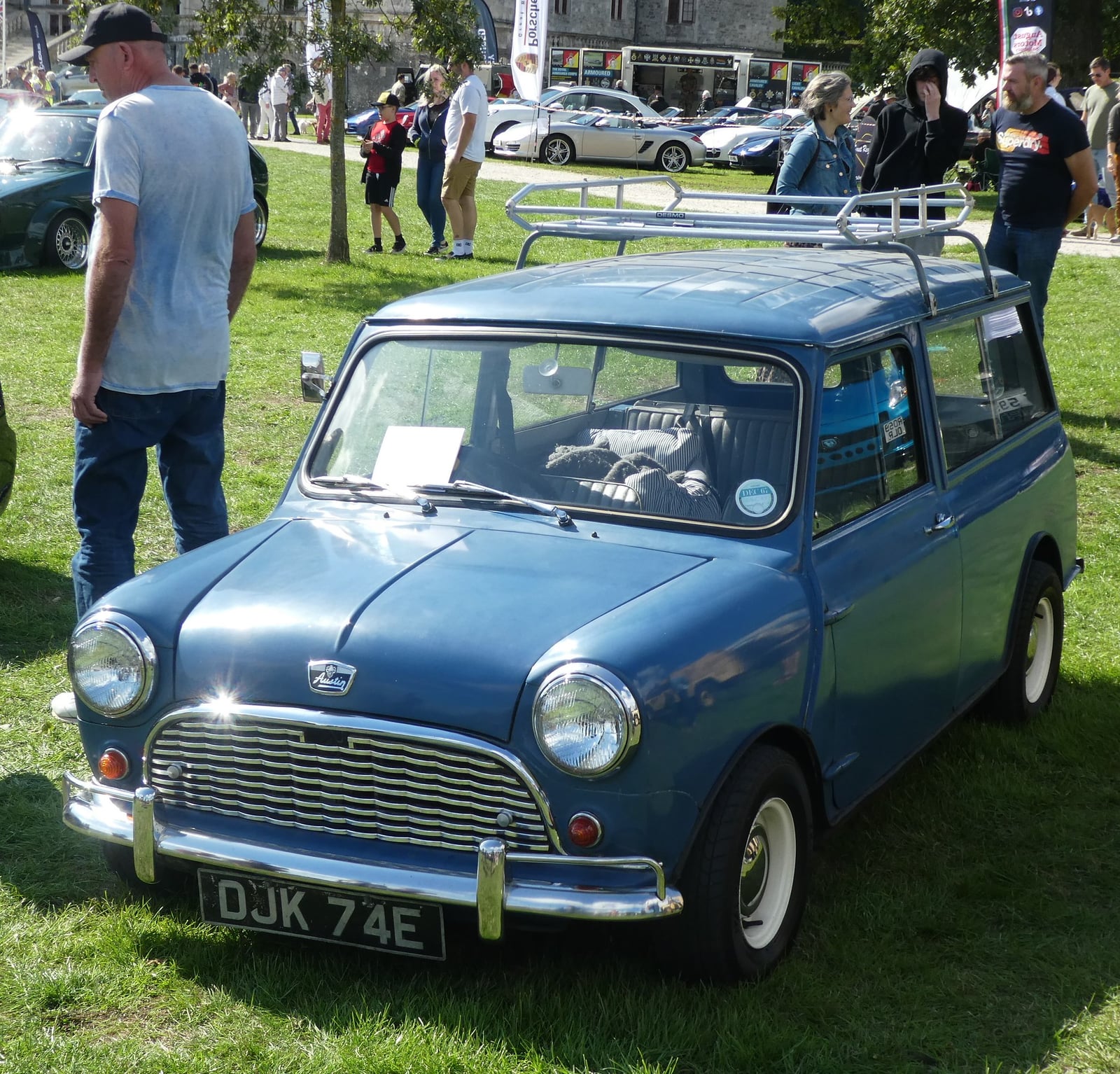 A blue all-steel Austin Mini Countryman with a roof rack, front three-quarter view