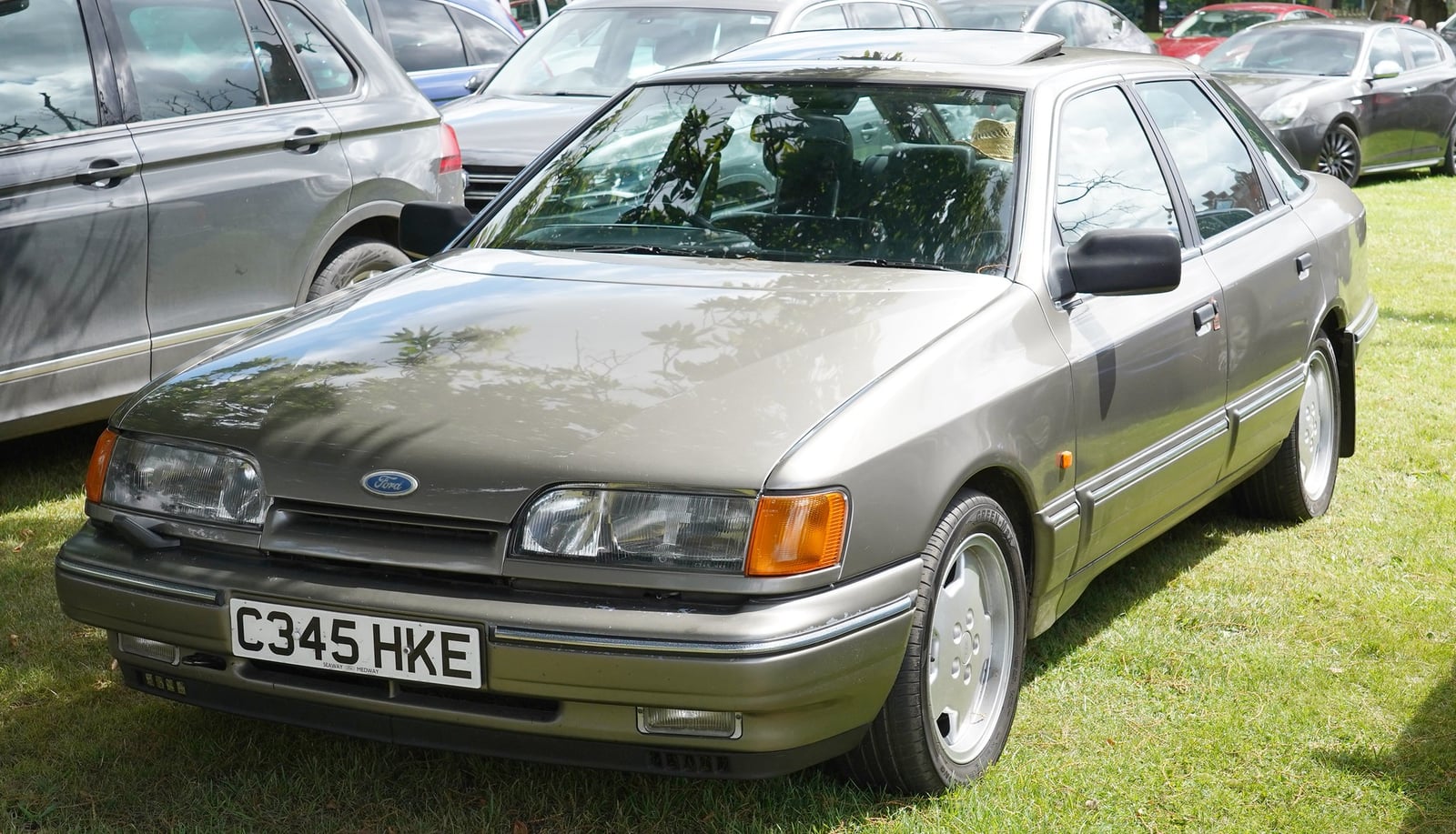A champagne Ford Granada Mk3 hatchback at a show, front three-quarter view
