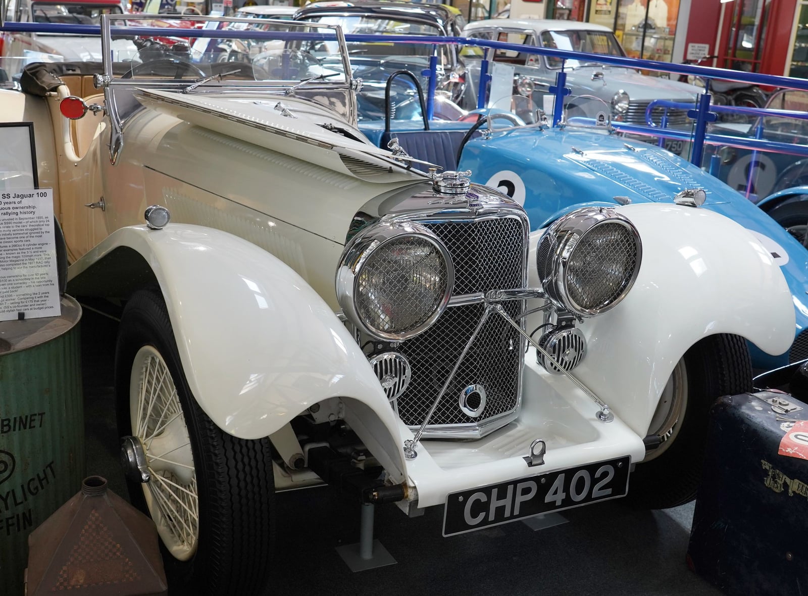 A cream SS Jaguar 100 in a museum, side view, UK registration CHP 402